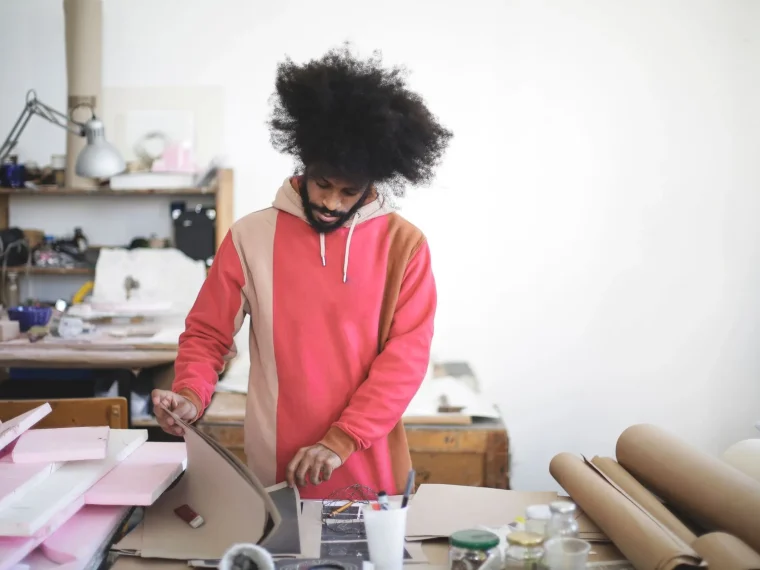 A well-lit workspace with a laptop showing digital art software, expert recommendations.